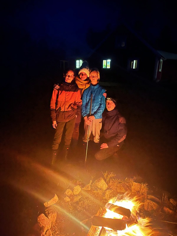 The family around the campfire at night
