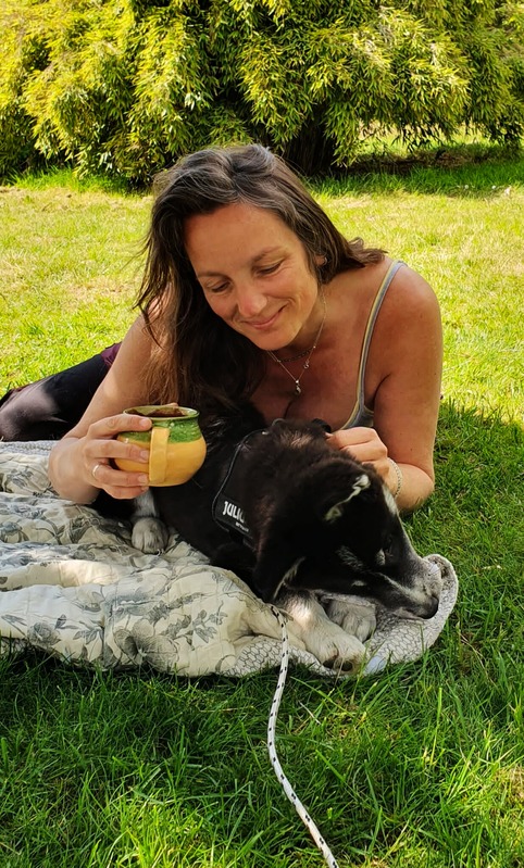 Marloes relaxing in the grass with our dog