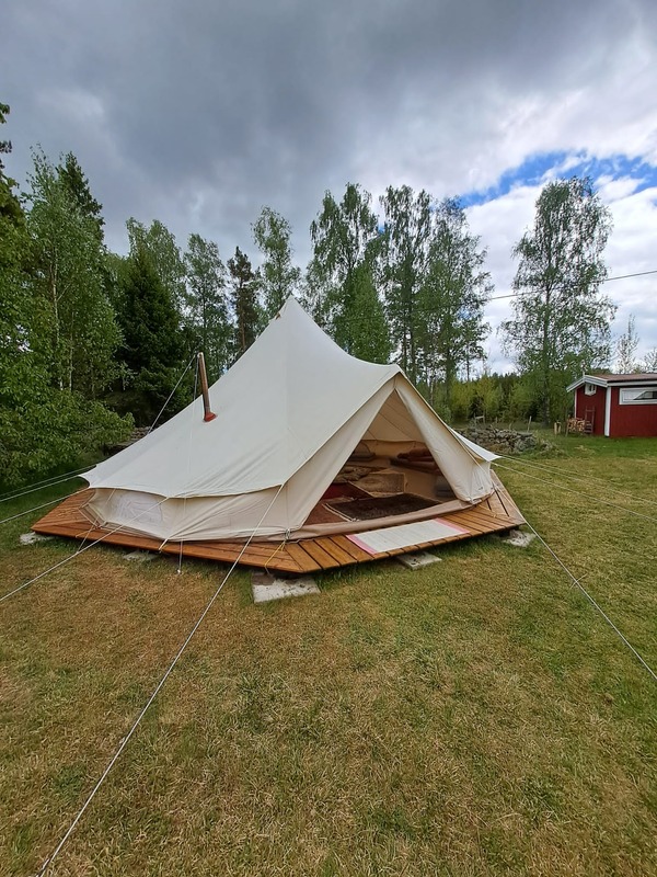 Our tipi tent pitched on a wooden deck