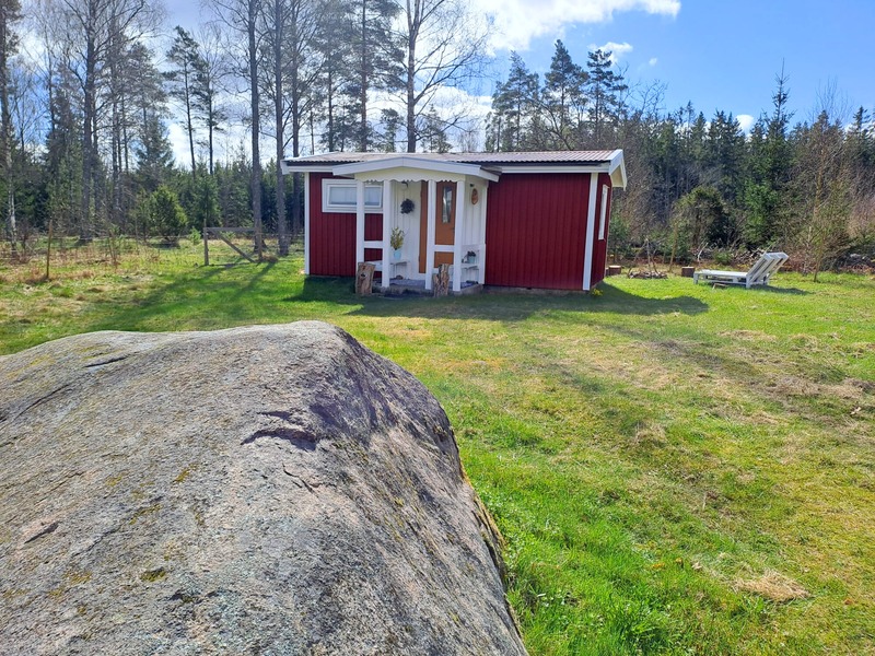 Our little red cabin beside a large rock