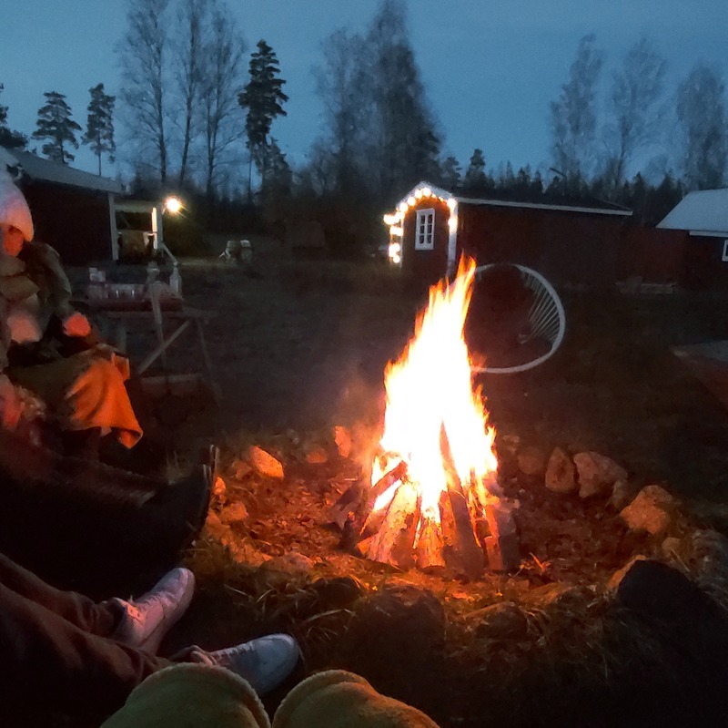 Campfire at dusk by the cabins