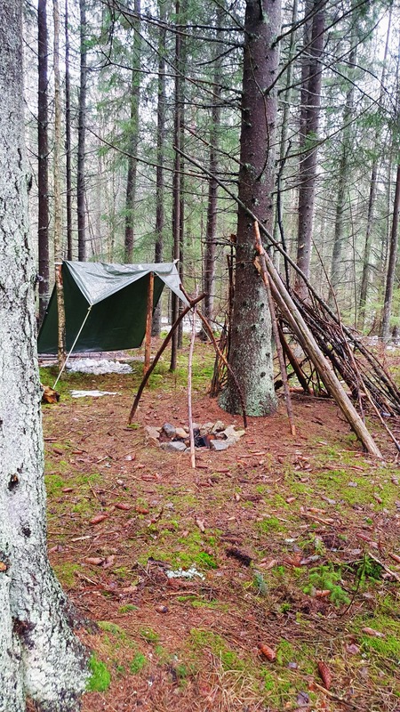 A handmade bushcraft shelter in the forest